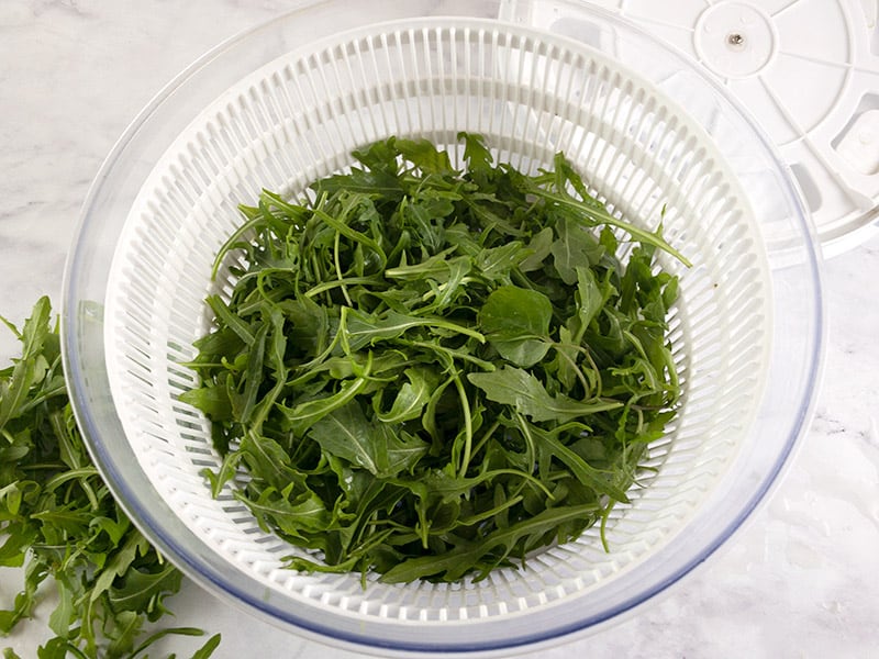 Arugula or rocket being dried in a salad spinner.