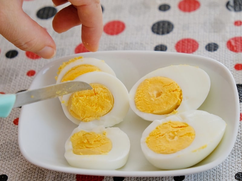 Cutting boiled eggs in half. 