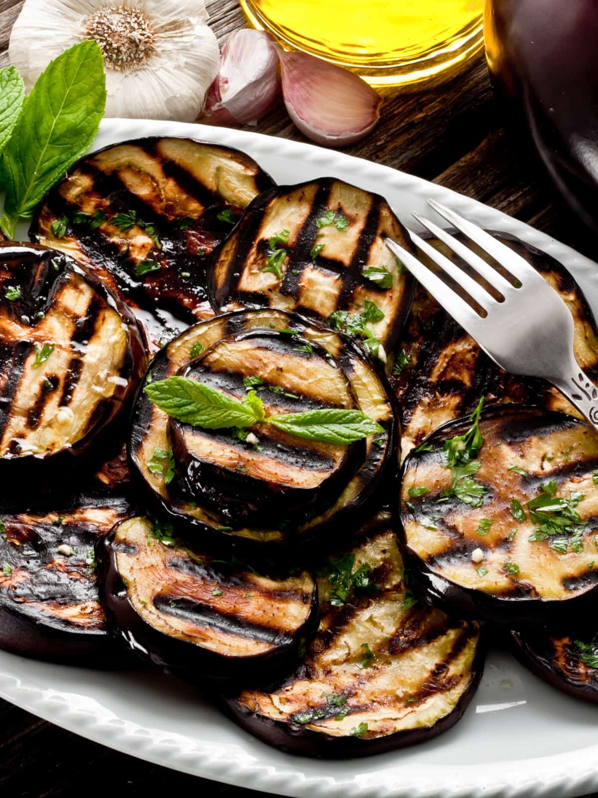 A plate of food on a table, with Grilled eggplant