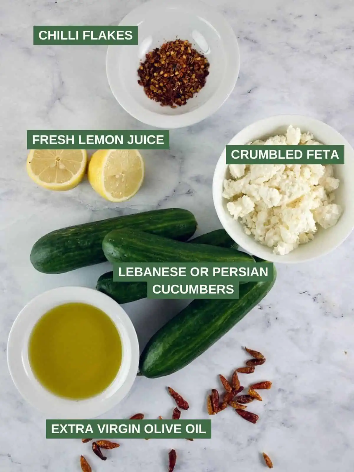 Labelled ingredients needed to make a feta cucumber salad.