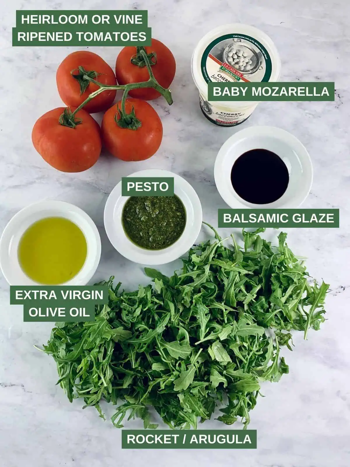 Labelled ingredients needed to make tomato mozzarella salad.