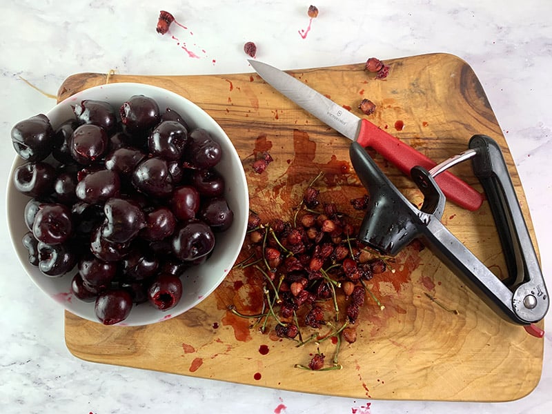PITTED CHERRIES ON BOARD WITH PITTER & KNIFE