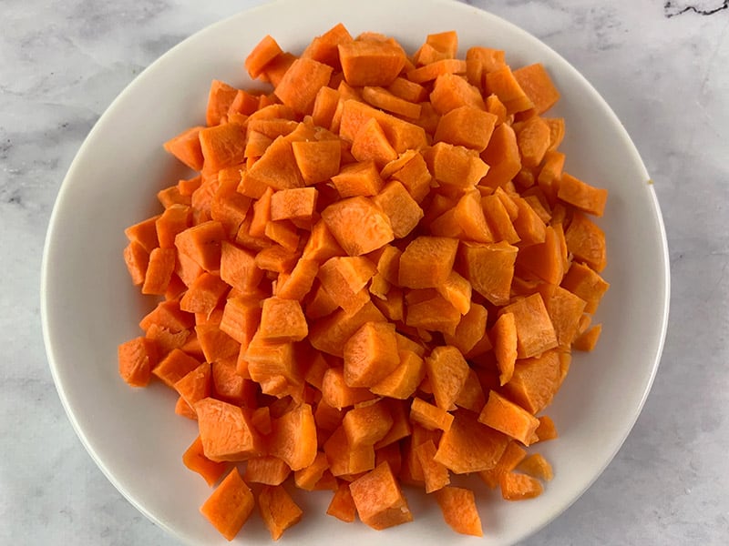 Diced carrots on a white plate. 