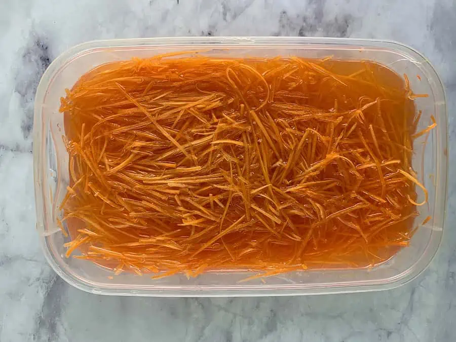 Julienned carrots in water. 