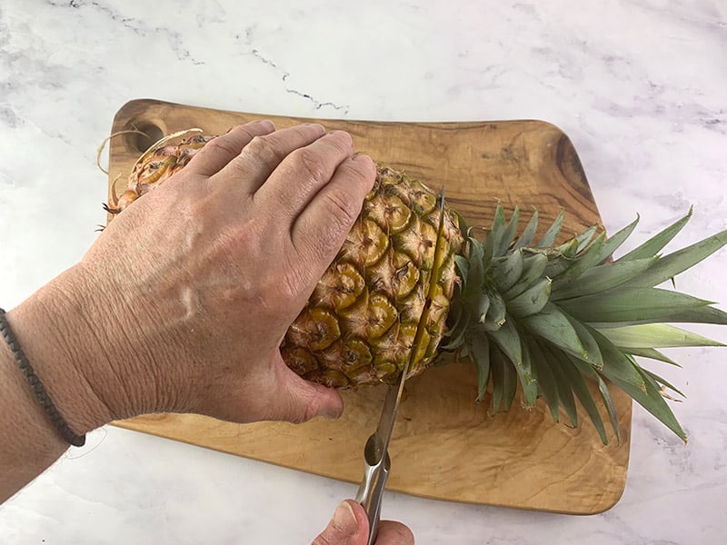 CUTTING THE CROWN FROM A PINEAPPLE