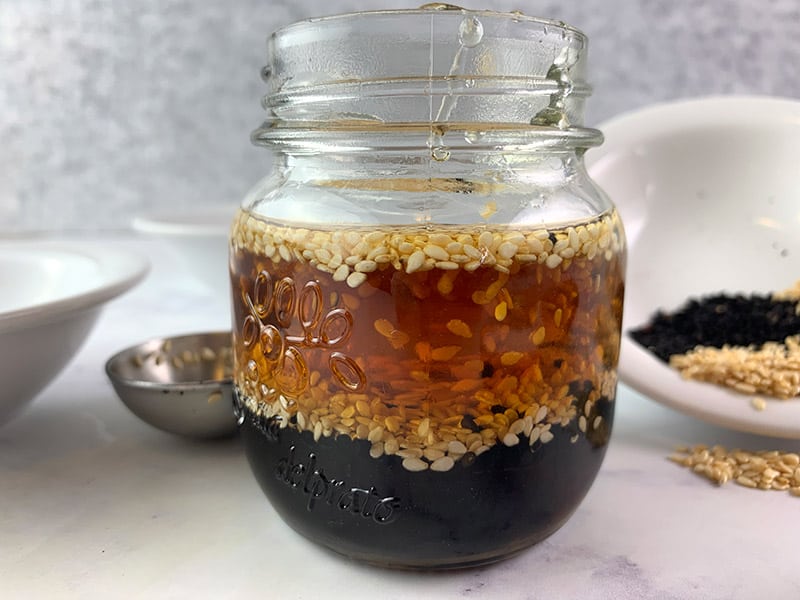 Sesame seed vinaigrette ingredients in a glass jar. 