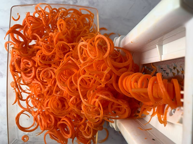 An aerial view of carrot spirals in a spiralizer.