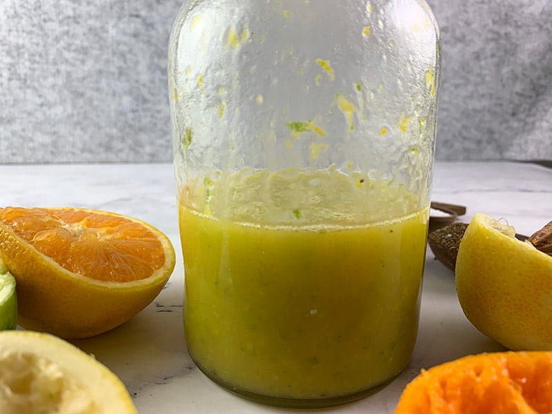 Shaken citrus vinaigrette in a glass jar.