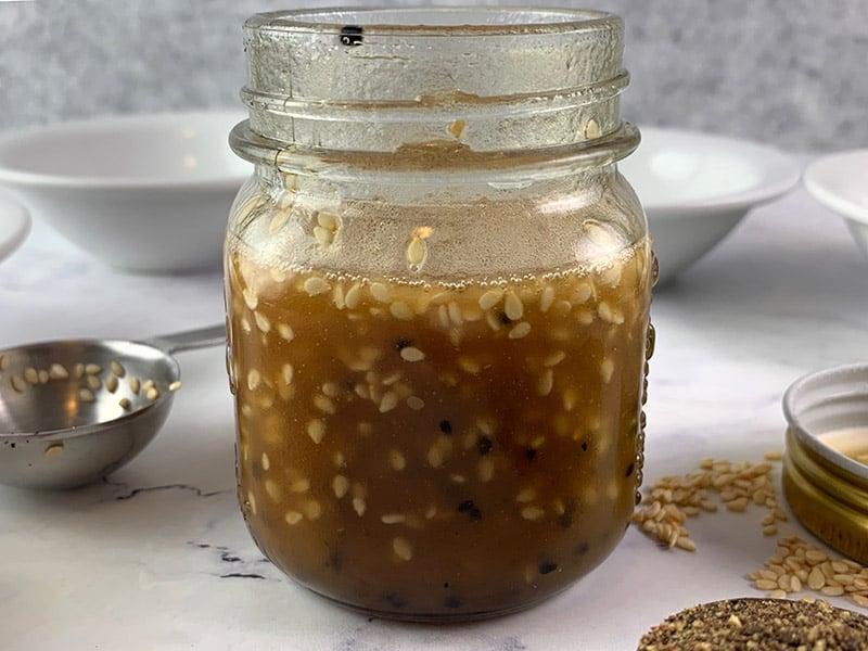 Shaken sesame seed dressing in a jar.