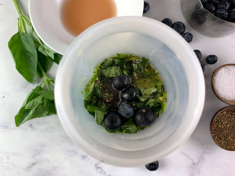 Blueberry basil salad dressing ingredients in a bowl.