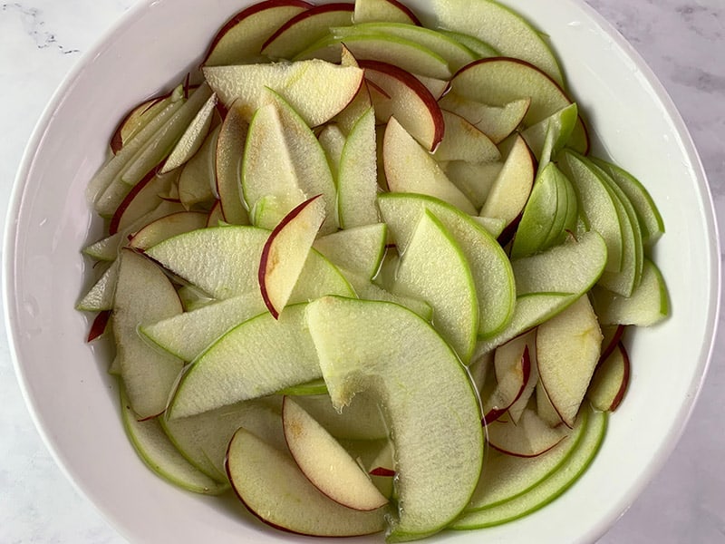 APPLE SLICES SUBMERGED IN SALTED WATER TO STOP BROWNING