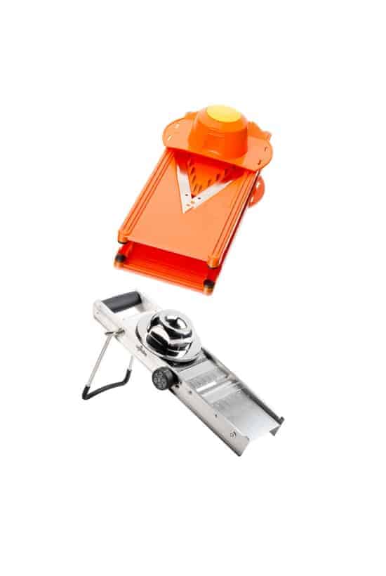 An orange v-slicer and a stainless steel mandoline slicer.