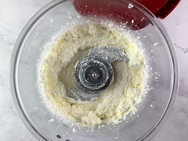 FETA BEING IN A FOOD PROCESSOR BEING BLITZED UNTIL SMOOTH