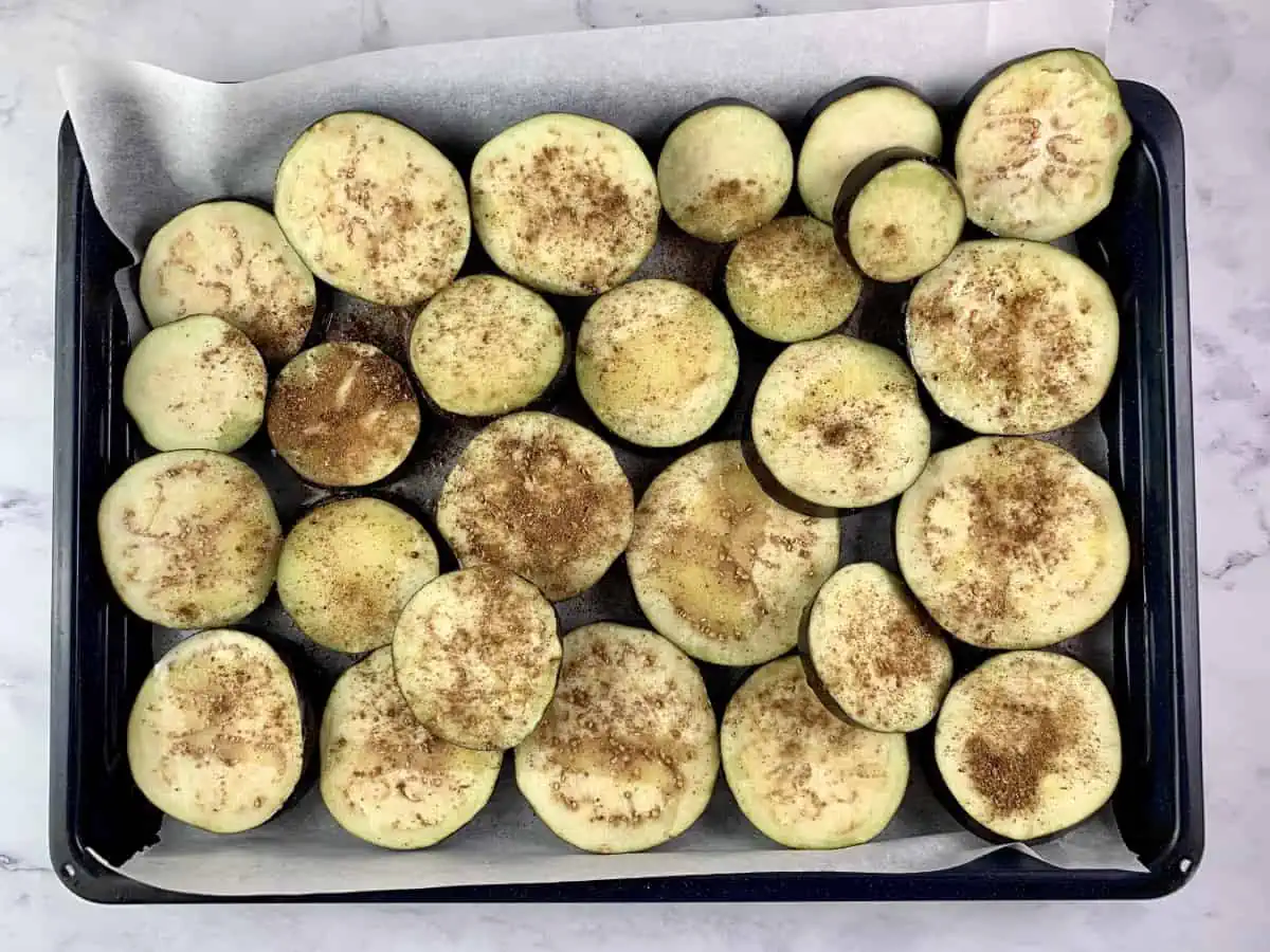 EGGPLANT ROUNDS ON A LINED BAKING TRAY WITH 5-SPICE