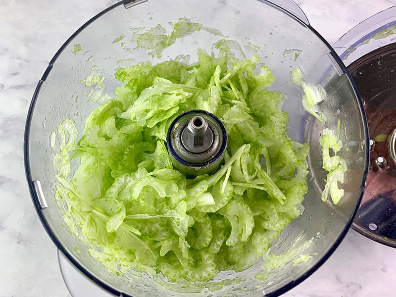 THINLY SLICED CELERY IN A FOOD PROCESSOR