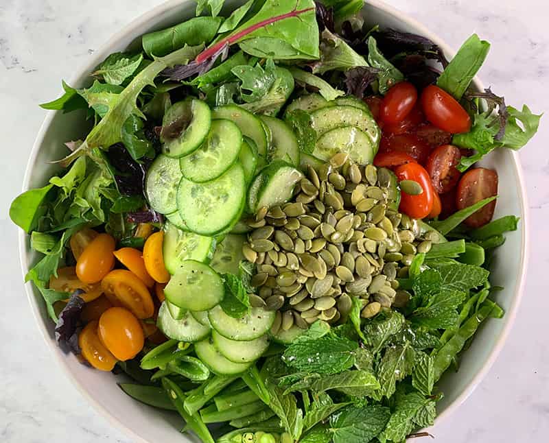 ALL THE INGREDIENTS FOR SPRING MIX SALAD IN A BOWL