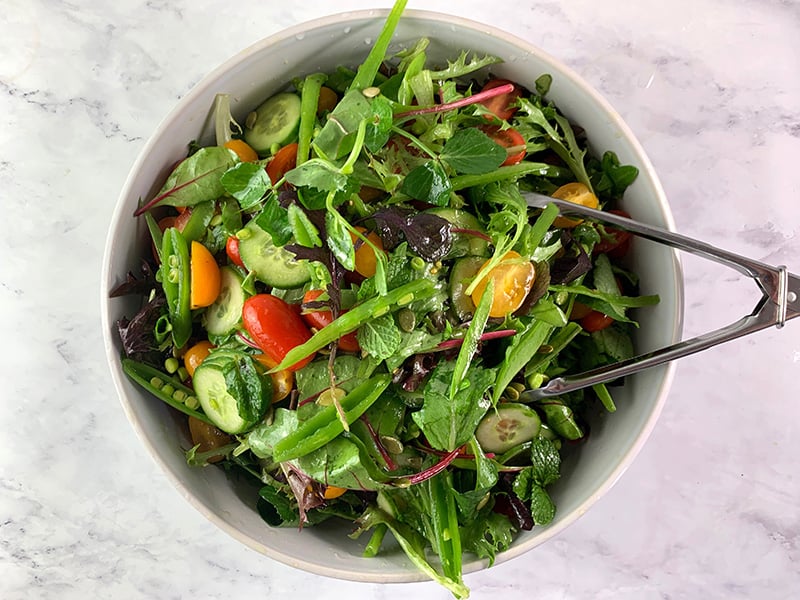 TOSSING SPRING MIX SALAD WITH DRESSING