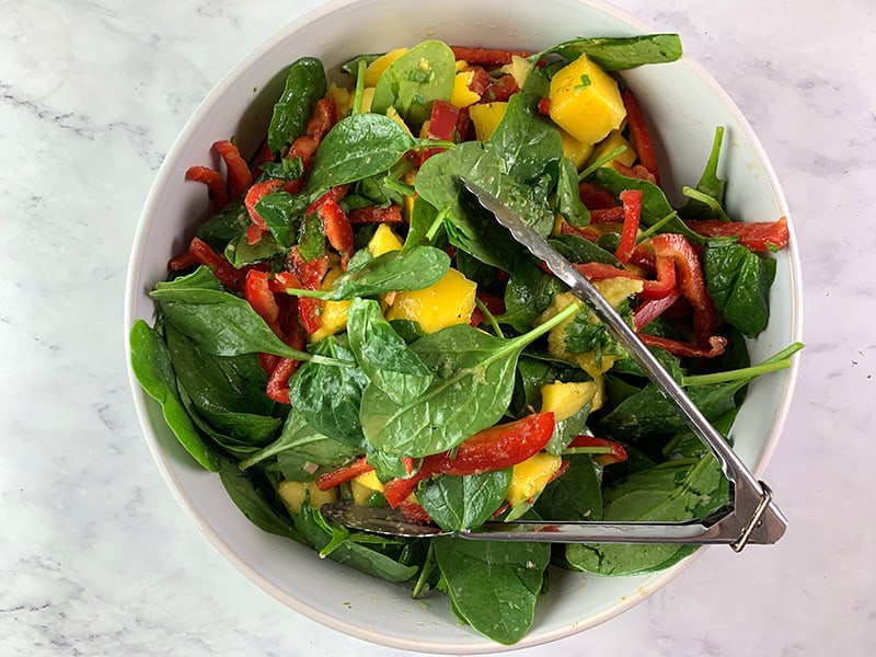 TOSSING THAI MANGO SALAD WITH DRESSING