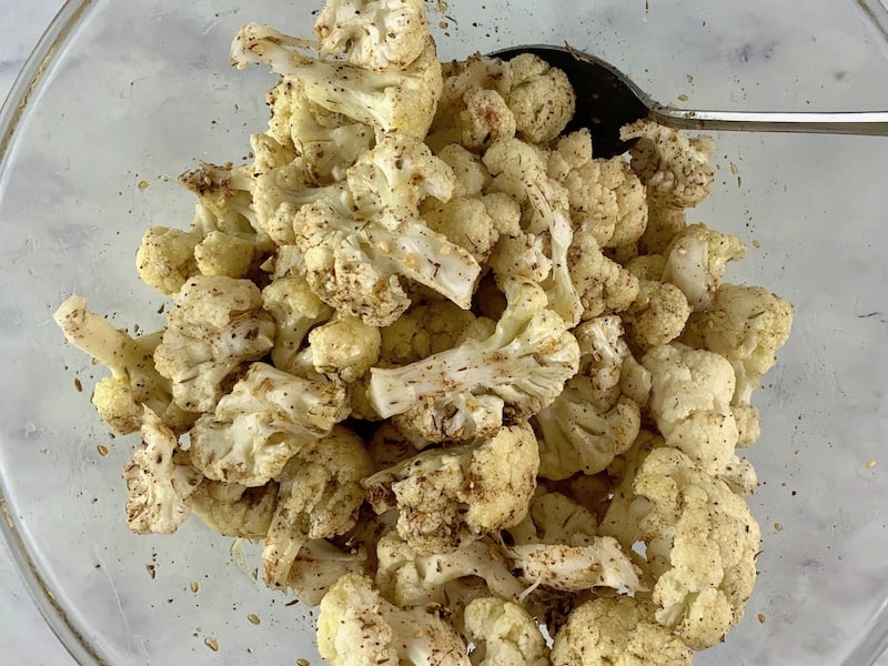 MIXING CAULIFLOWER FLORETS WITH OIL & ZA'ATAR IN BOWL