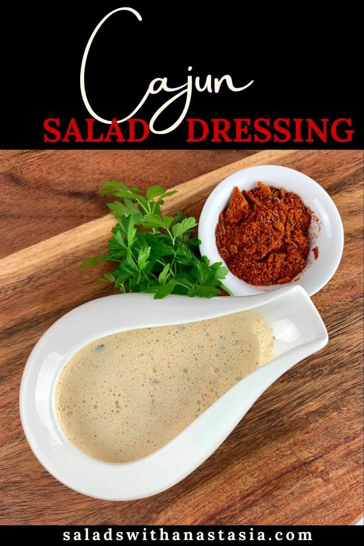 CAJUN SALAD DRESSING IN A WHITE BOWL WITH CAJUN SPICE & PARSLEY GARNISH ON A WOODEN BOARD WITH TEXT OVERLAY