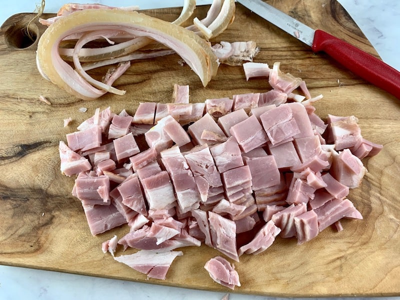 DICE BACON RASHERS on wooden board with knife