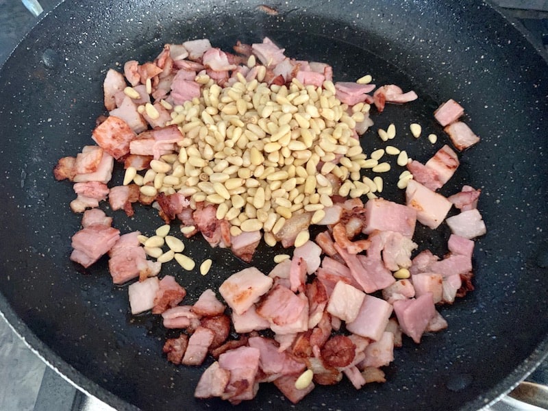 ADD PINE NUTS TO DICED BACON IN PAN
