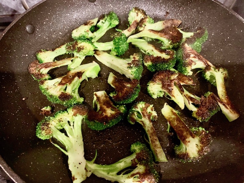 BROCCOLI FLORETS CHARRED ON ONE SIDE IN PAN