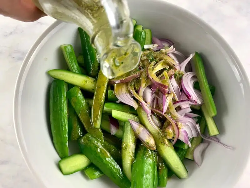 POURING DRESSING OVER ITALIAN CUCUMBER SALAD INGREDIENTS