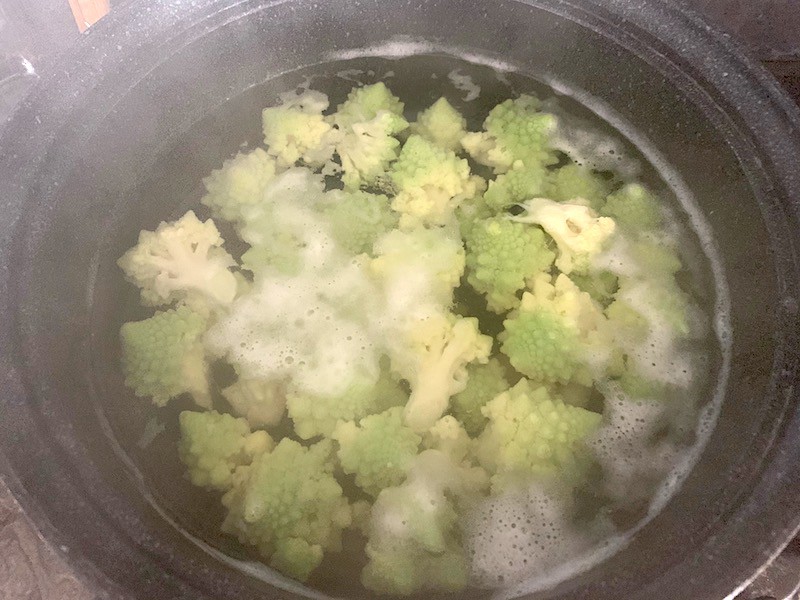 ROMANESCO FLORETS BOILING IN POT OF WATER ON STOVE