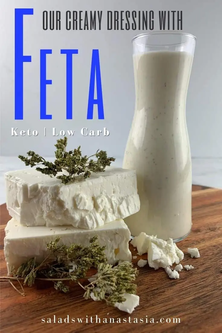 CREAMY FETA DRESSING IN GLASS BOTTLE WITH FETA & DRIED OREGANO ON A WOODEN BOARD WITH TEXT OVERLAY