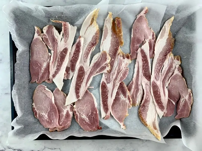 RAW BACON RASHERS ON A LINED OVEN TRAY