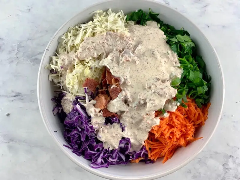 POURING BACON DRESSING OVER KETO COLESLAW INGREDIENTS