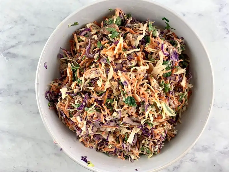 MIXING COLESLAW IN A MIXING BOWL TO COMBINE