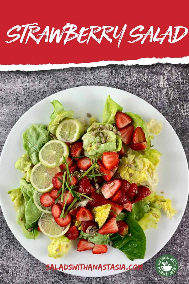 AERIAL VIEW OF BUTTER LETTUCE AND STRAWBERRY SALAD ON WHITE PLATTER WITH DARK GREY BACKGROUND WITH TEXT OVERLAY