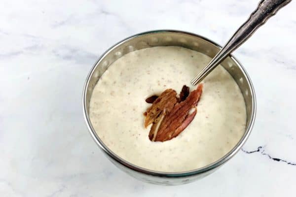 CREAMY BACON DRESSING IN A SILVER BOWL WITH SPOON