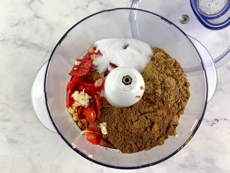 ALL INGREDIENTS FOR HARISSA PASTE IN THE BOWL OF A FOOD PROCESSOR
