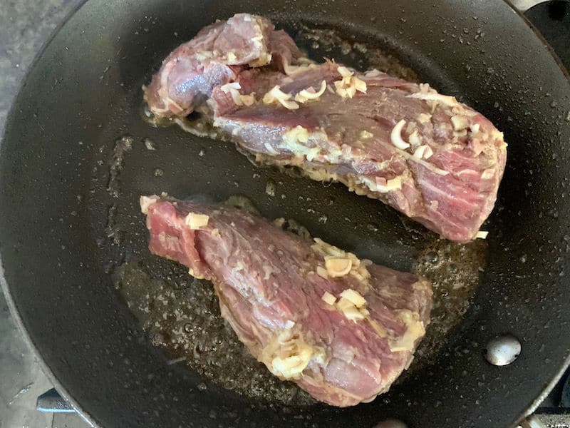 ADDING BEEF FILLETS TO HOT PAN