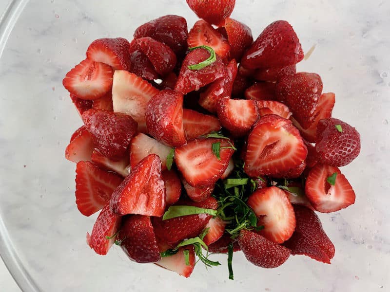 STRAWBERRY FRUIT SALAD INGREDIENTS IN A GLASS BOWL