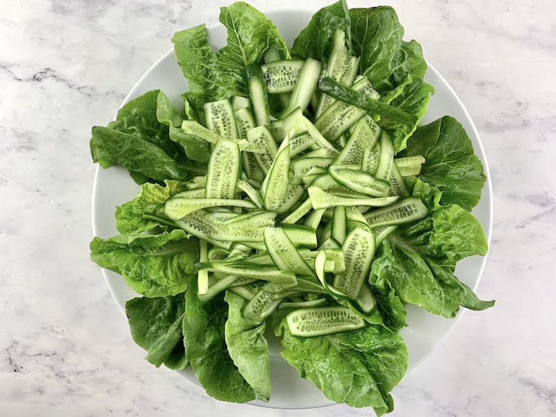 CUCUMBER RIBBONS ON TOP OF LETTUCE LEAVES
