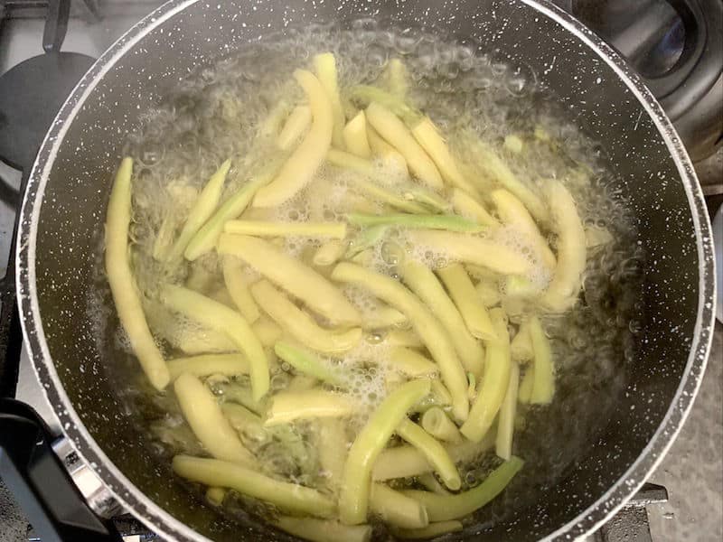 YELLOW BEANS BOILING IN POT ON STOVE