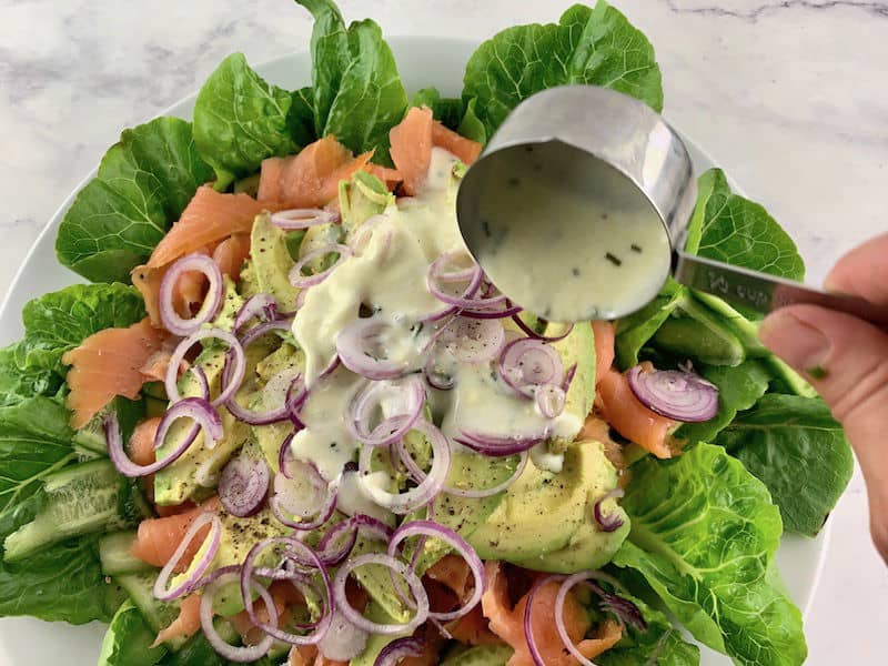 POURING BUTTERMILK DRESSING OVER SMOKED SALMON SALAD