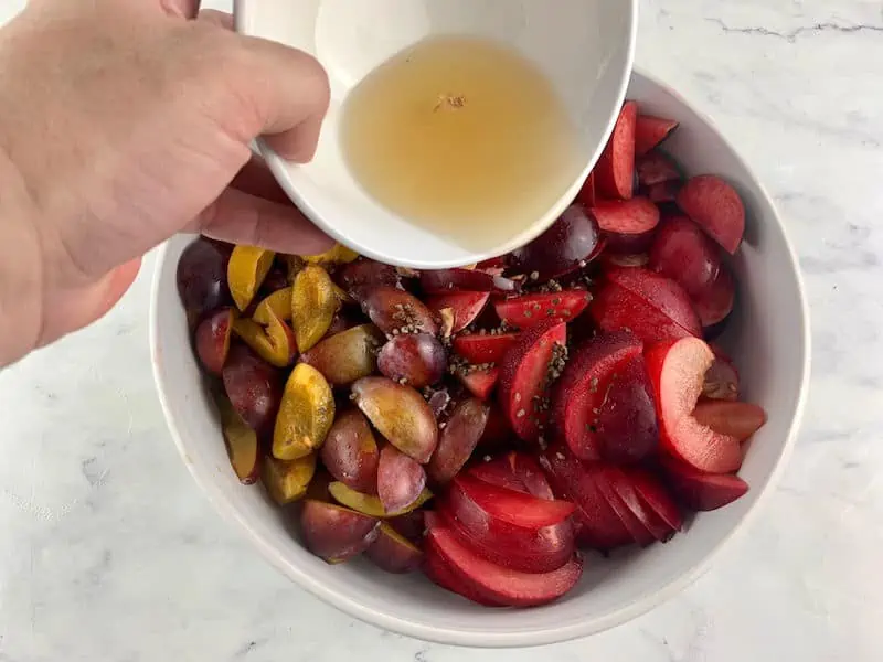 POURING OVER COOLED SYRUP ON PLUMS