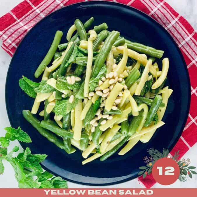 Yellow Bean Salad on a blue plate sitting on red & white tea towel and mint sprig on the side with a Xmas text overlay.