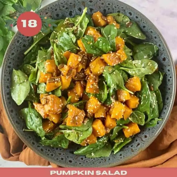 Pumpkin salad in a dark grey patterned plate with the number 18 and text overlay.
