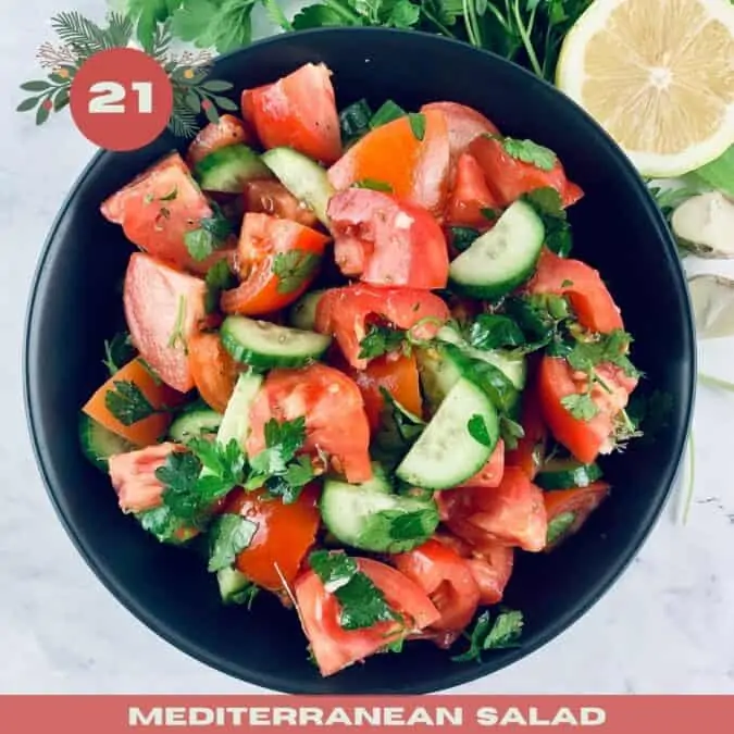 Mediterranean tomato and cucumber salad in a black bowl with the number 25 and text overlay.