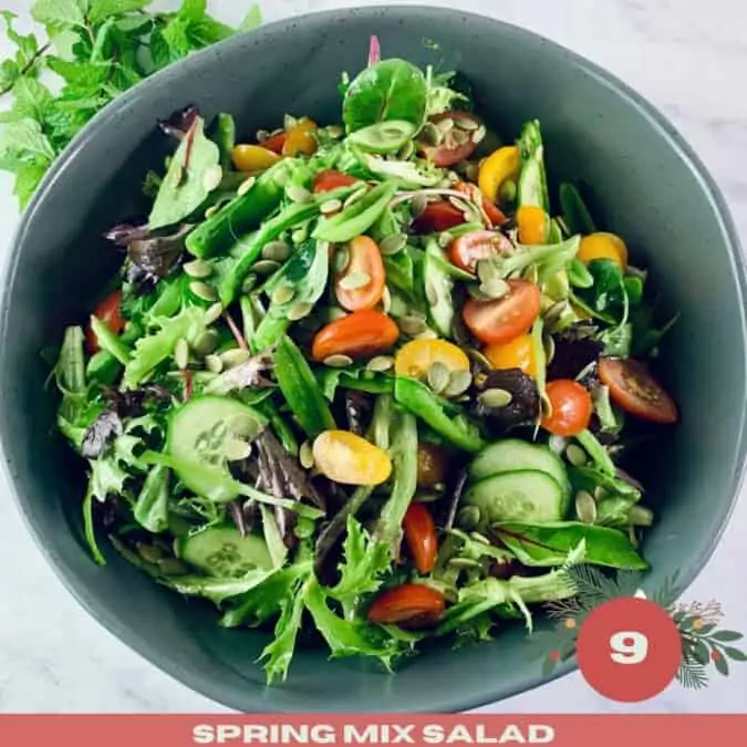 Spring Mix Salad in a dark grey bowl with mint sprigs in top left corner and with Xmas text overlay.