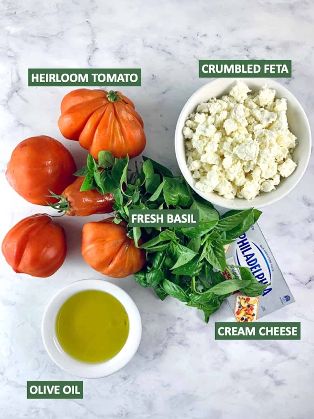 Labelled ingredients needed to make heirloom tomato salad.