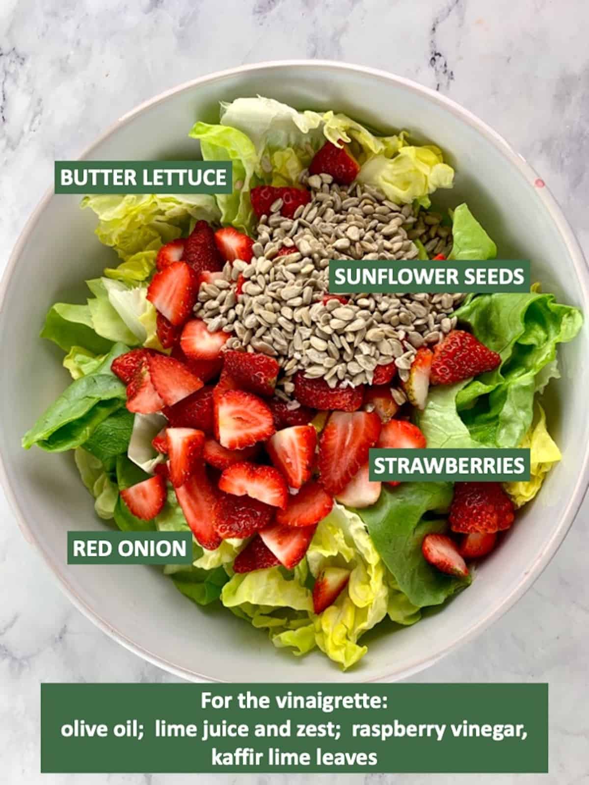Labelled ingredients needed to make lettuce salad with strawberries.