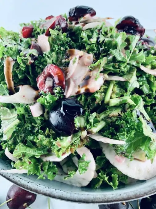A close-up of kale, fennel and brie salad.