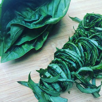 Stacked basil leaves on left, basil chiffonade on right.